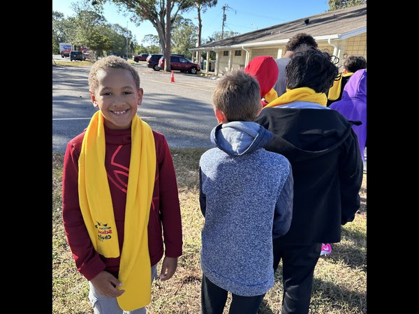 Agape Christian School students wearing yellow scarfs